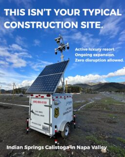Solar-powered mobile surveillance trailer providing construction site security at active luxury resort